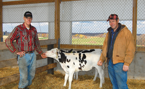 Farmers with calf