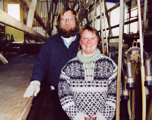 Farmers in milking parlor