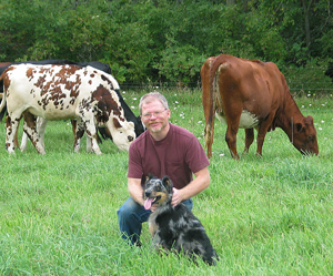 Farmer with dog and cows