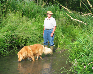 Farmer with dog in stream